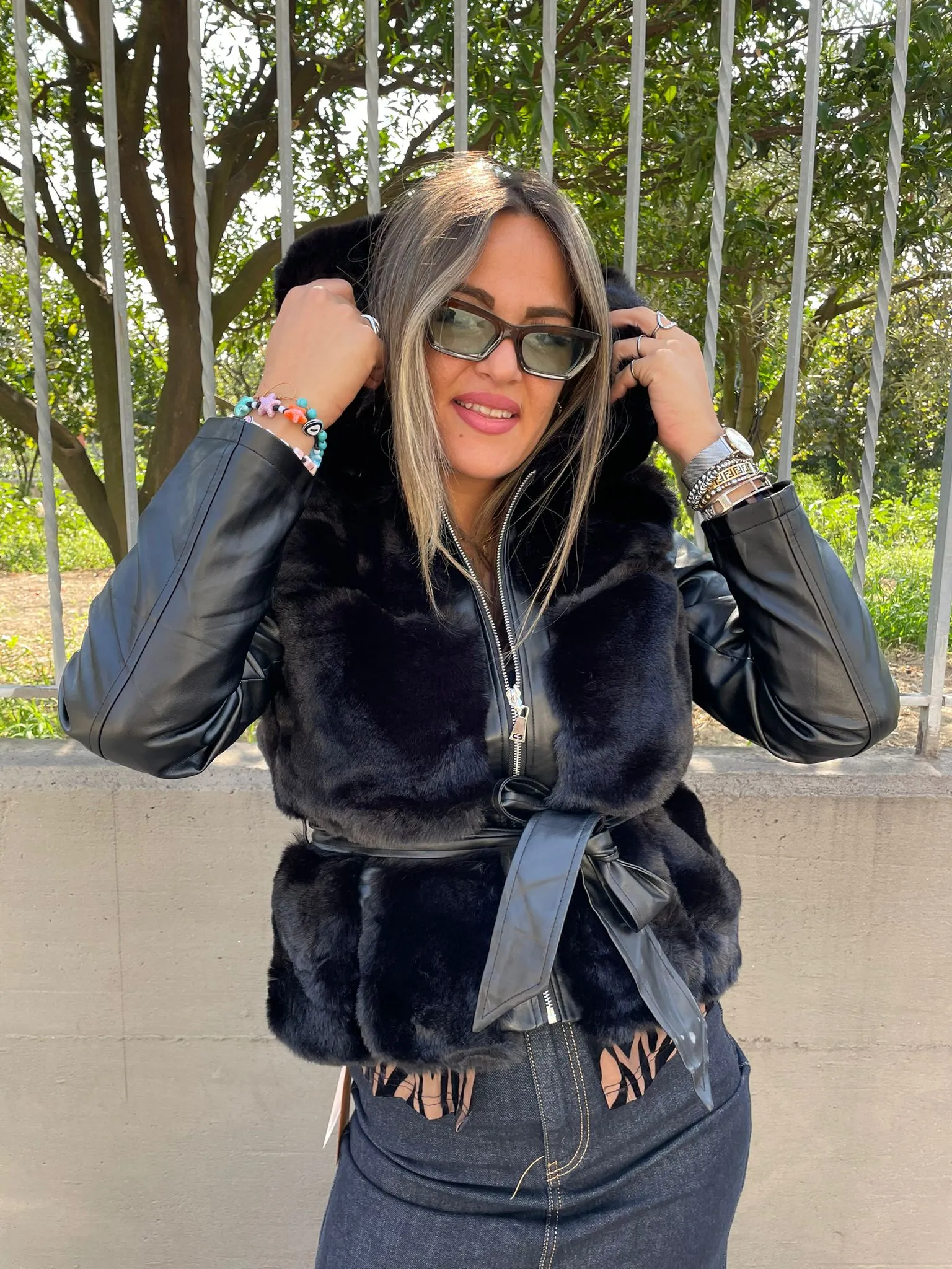 Black fur coat with faux leather sleeves.